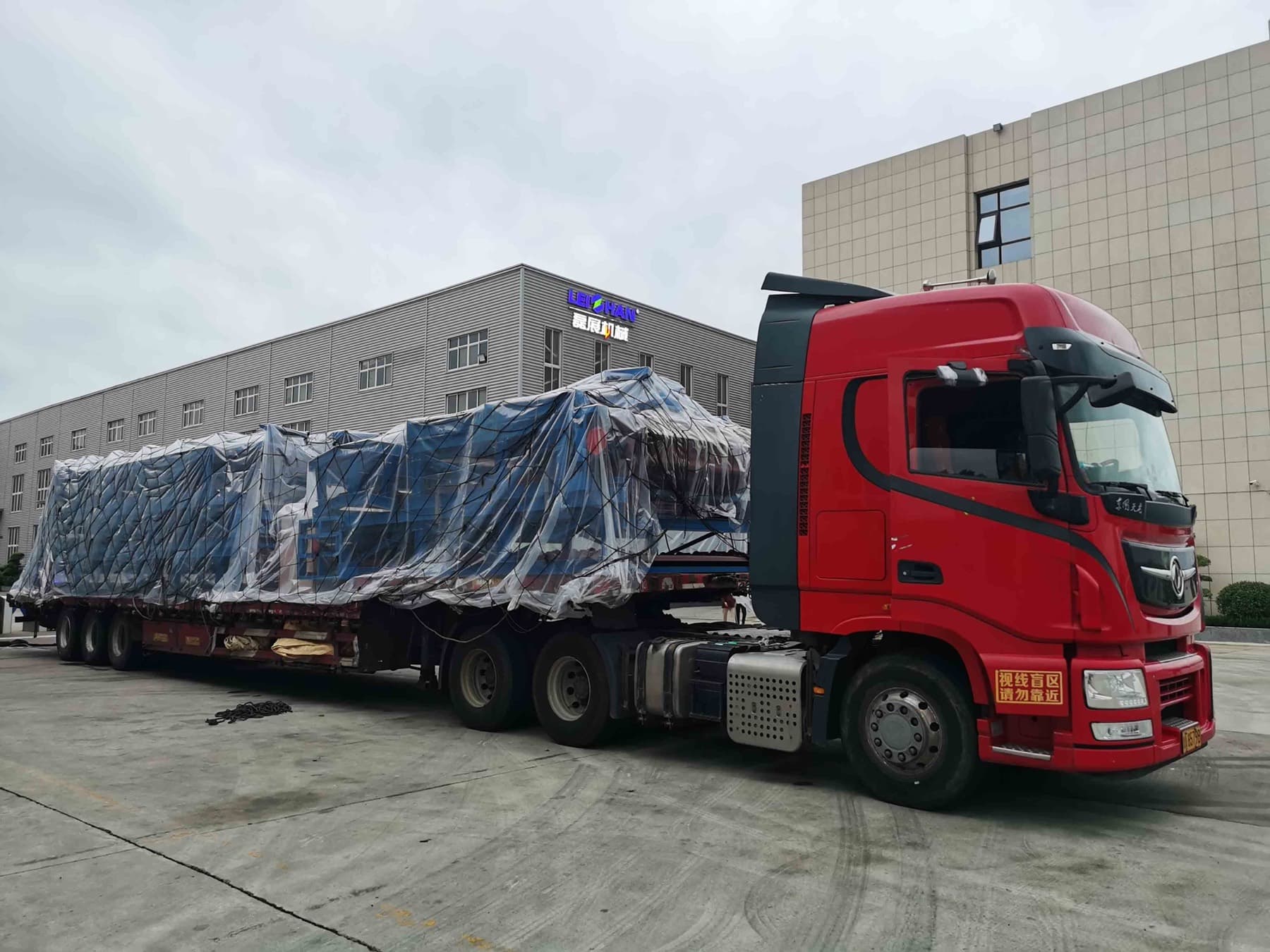 Loaded tractor-trailer parked at a yard waiting on service
